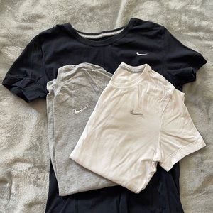 Black, white, and grey Nike slim fit workout shirts